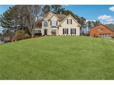 Two-story house with a large front yard and a basketball court at 2035 Walnut Creek Xing, Alpharetta, GA 30005