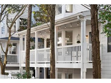 Charming white home exterior with a covered porch and string lights, offering a cozy outdoor space at 951 Glenwood Se Ave # 1201, Atlanta, GA 30316