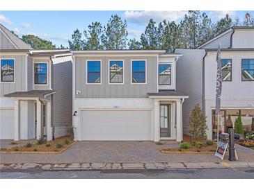 Gray two-story home with white garage door and landscaping at 731 Stickley Oak Way, Woodstock, GA 30189