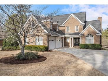 Brick house with a three-car garage and manicured lawn at 1255 Kincaid Rd, Marietta, GA 30066