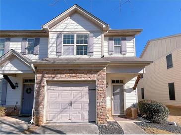 Two-story townhome with stone accents and a two-car garage at 4222 High Park Ln, Atlanta, GA 30344