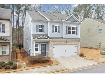 Two-story house with gray siding, brick accents, and a two-car garage at 236 Hickory Commons Way, Canton, GA 30115