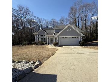 Gray two-story house with attached garage and landscaping at 4053 Chapel Mill Bnd, Decatur, GA 30034