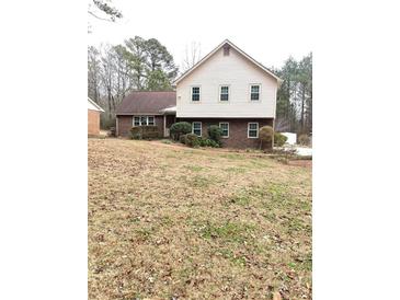 Two-story house with brick and siding, featuring a well-maintained lawn at 9082 Chestnut Lake Dr, Jonesboro, GA 30236