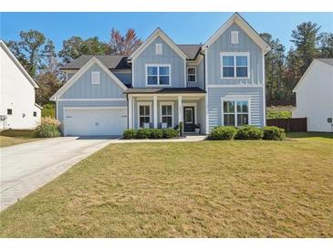 Two-story farmhouse with gray siding, white trim, and a landscaped lawn at 2044 Garvin Rd, Acworth, GA 30101
