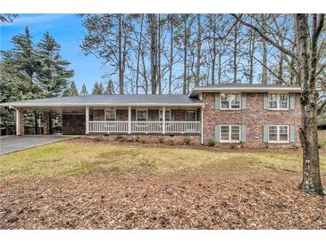 Brick ranch house with carport, covered porch, and landscaped yard at 2791 Ponderosa Cir, Decatur, GA 30033