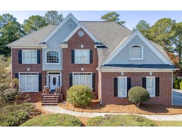 Two-story brick home with gray accents and landscaped yard at 2555 Lynshire Ln, Snellville, GA 30078