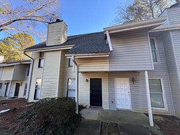 Two-story townhome with front entrance and landscaping at 4411 Idlewood Ln, Tucker, GA 30084