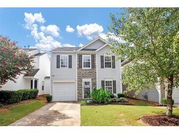 Two-story house with gray siding, stone accents, and a grassy front yard at 5140 Sky Ridge Way, Cumming, GA 30041