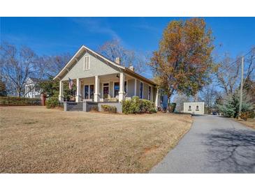 Charming craftsman home with a spacious lawn and long driveway at 5143 Floyd Ne St, Covington, GA 30014