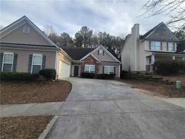 Two-story house with gray siding, brick accents, and a two-car garage at 658 Austin Creek Dr, Buford, GA 30518