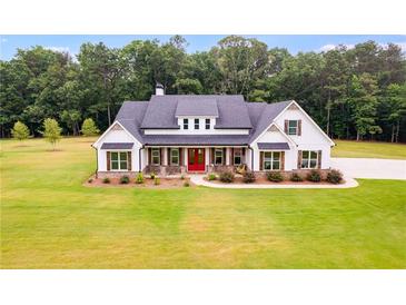 Two-story farmhouse with white exterior, red door, and large windows at 350 Taylor Path, Dallas, GA 30157
