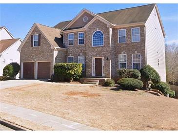 Brick two-story house with attached two-car garage and landscaping at 5320 Coventry Creek Dr, Cumming, GA 30040