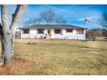 Newly renovated home with a white exterior, landscaping, and spacious yard at , Loganville, GA 30052