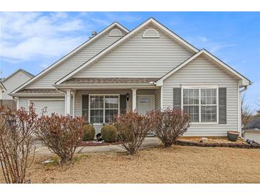 Charming one-story house with a well-manicured lawn and shrubs at 303 Breezy Hill Walk, Stockbridge, GA 30281