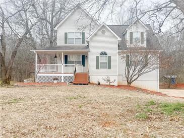 Two-story house with front porch, mature trees, and landscaping at 406 River Walk, Douglasville, GA 30134