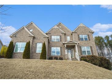 Brick two-story house with a landscaped yard and large windows at 420 Silver Brook Dr, Woodstock, GA 30188