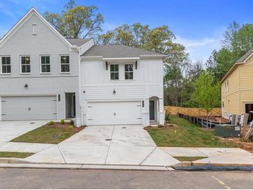 Two-story townhome with gray and white exterior, two-car garage, and landscaped lawn at 746 Trevett Way, Marietta, GA 30062