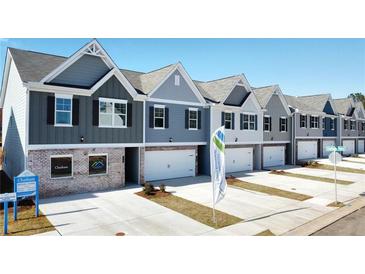 New townhome community with multiple units, featuring modern gray siding and brick accents at 11575 Chatham Dr, Hampton, GA 30228