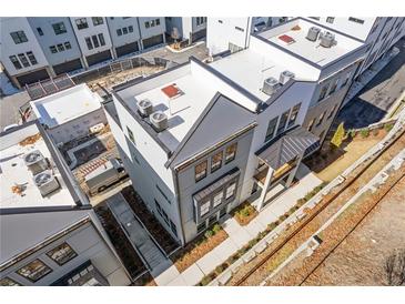 Modern townhome with gray exterior and rooftop units; located near train tracks at 1779 Beckham Ne Pl # 58, Atlanta, GA 30324