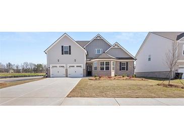Two-story house with a three-car garage and landscaping at 13561 Whitman Ln, Covington, GA 30014