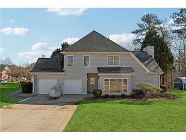 Two-story house with attached garage and landscaped yard at 4497 Black Water Cv, Ellenwood, GA 30294