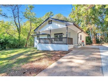 Newly renovated house featuring a front porch and driveway at 1679 Hollyhock Ter, Decatur, GA 30032