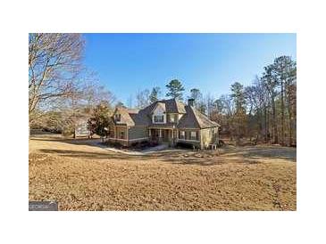 Two story house with large windows and attached garage at 283 Rosebay Ln, Sharpsburg, GA 30277