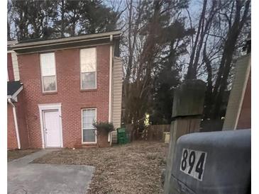 Brick townhouse with a small front yard and mailbox at 894 Glynn Oaks Dr, Clarkston, GA 30021