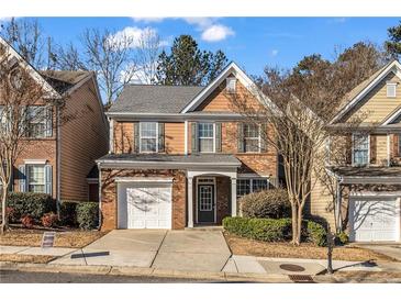 Charming two-story home with brick accents, manicured lawn, and attached one car garage at 1538 Park Grove Dr, Lawrenceville, GA 30046