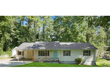 Charming ranch home with covered porch and landscaped yard at 102 Chip Pl, Stockbridge, GA 30281