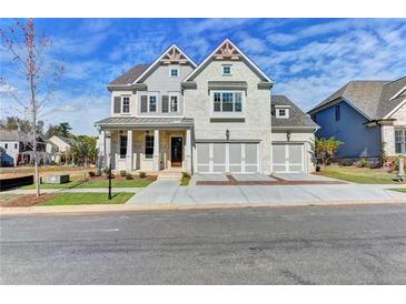 Two-story house with gray siding, three-car garage, and landscaped yard at 11255 Knollwood Bnd, Johns Creek, GA 30097