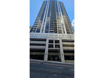 High-rise building exterior with parking and street view at 1280 W Peachtree W St # 1407, Atlanta, GA 30309