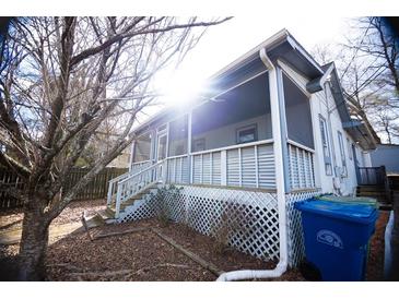 Charming house with a wrap-around porch and a spacious yard at 744 Law Nw St, Atlanta, GA 30318