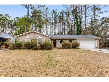 Ranch style home with brick facade and attached garage at 2828 The Meadows Way, Atlanta, GA 30349