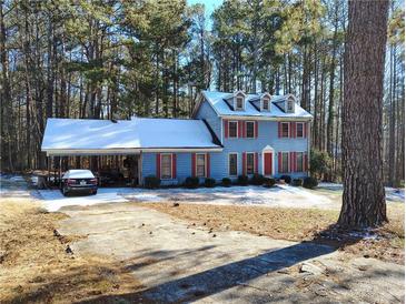 Two-story house with snow covered roof and red shutters at 804 Bankshire Dr, Suwanee, GA 30024