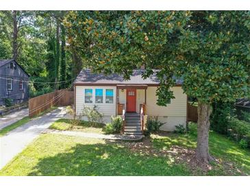 Charming single-story home with a manicured front lawn and a vibrant orange front door at 1256 Elizabeth Ave, Atlanta, GA 30310