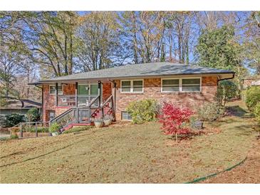 Brick ranch house with a landscaped yard and attached deck at 2289 Montrose Dr, East Point, GA 30344