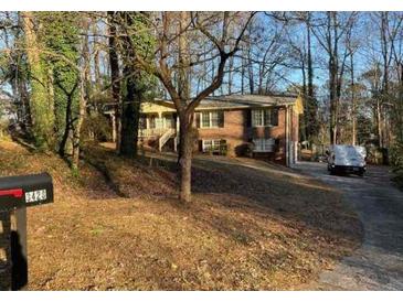 Brick ranch home with driveway and mature trees at 3428 Vandiver Dr, Marietta, GA 30066