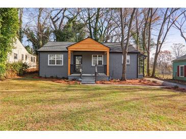 Charming gray house with wood accents and a well-manicured lawn at 1534 Alma Sw St, Atlanta, GA 30311