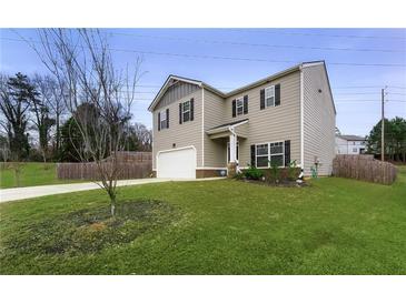 Two-story house with gray siding, a white garage door, and a landscaped yard at 3720 Liverpool Way, Atlanta, GA 30331