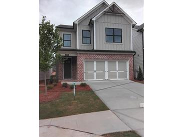 Charming two-story home with a two-car garage, brick accents and a beautifully landscaped front yard at 1070 Crest Mill Dr, Marietta, GA 30008