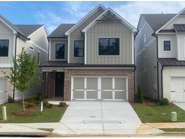 Charming two-story home with a brick-accented facade and white garage doors in a modern style at 1070 Crest Mill Dr, Marietta, GA 30008