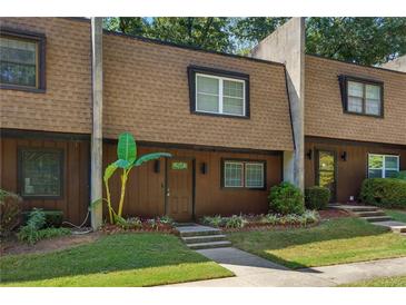 Brown townhome with landscaping and a walkway at 729 Cedar Pointe Sw Ct, Marietta, GA 30008