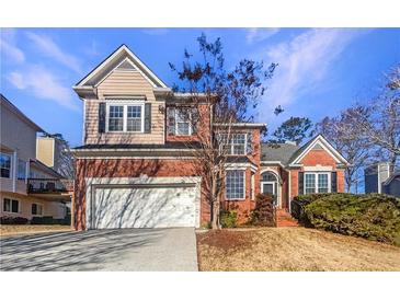 Brick two-story house with a large attached garage and manicured lawn at 3905 Colonial Sw Trl, Lilburn, GA 30047