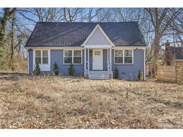 Charming blue house with white trim and a covered porch at 1974 Browns Mill Se Rd, Atlanta, GA 30315