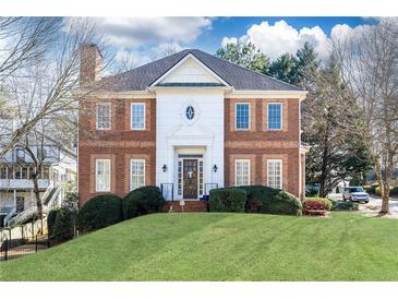 Brick two-story house with a manicured lawn at 63 Habersham Cove Nw Ln, Atlanta, GA 30305