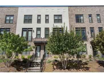 3-story townhome with brick facade and private balcony at 1577 Aldworth Se Pl, Atlanta, GA 30339