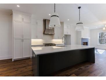 Modern kitchen with stainless steel appliances and white cabinetry at 1072 Green St, Roswell, GA 30075