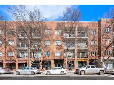 Brick building exterior with ample parking and street-level retail at 333 Nelson Sw St # 404, Atlanta, GA 30313